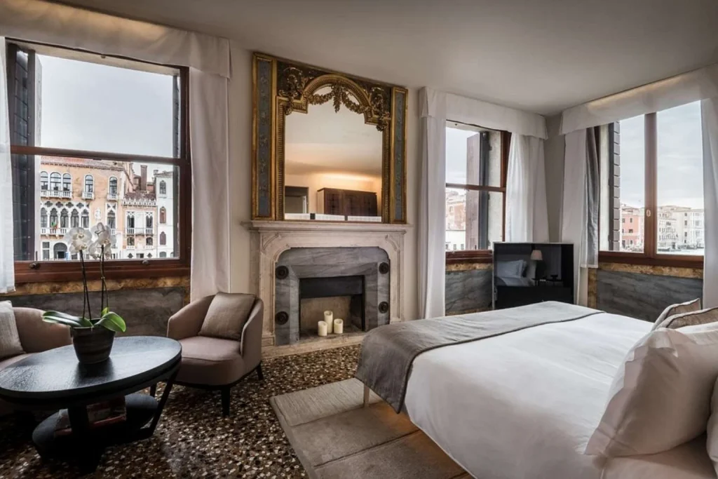 Elegant guest room with historic details, large windows and panoramic views across the Grand Canal, Aman Venice, Venice.
