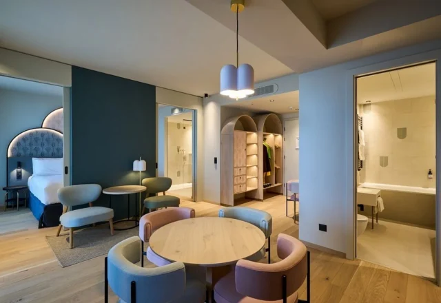 Spacious modern family suite with a separate sleeping area, dining space and contemporary bathroom, Cavallino Bianco Caorle, Caorle.