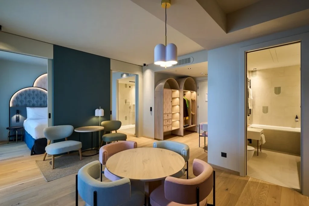 Spacious modern family suite with a separate sleeping area, dining space and contemporary bathroom, Cavallino Bianco Caorle, Caorle.