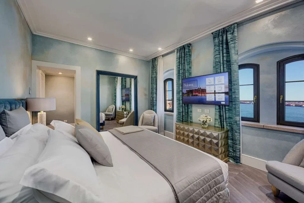 Elegant bedroom with lagoon view at Hilton Molino Stucky Venice