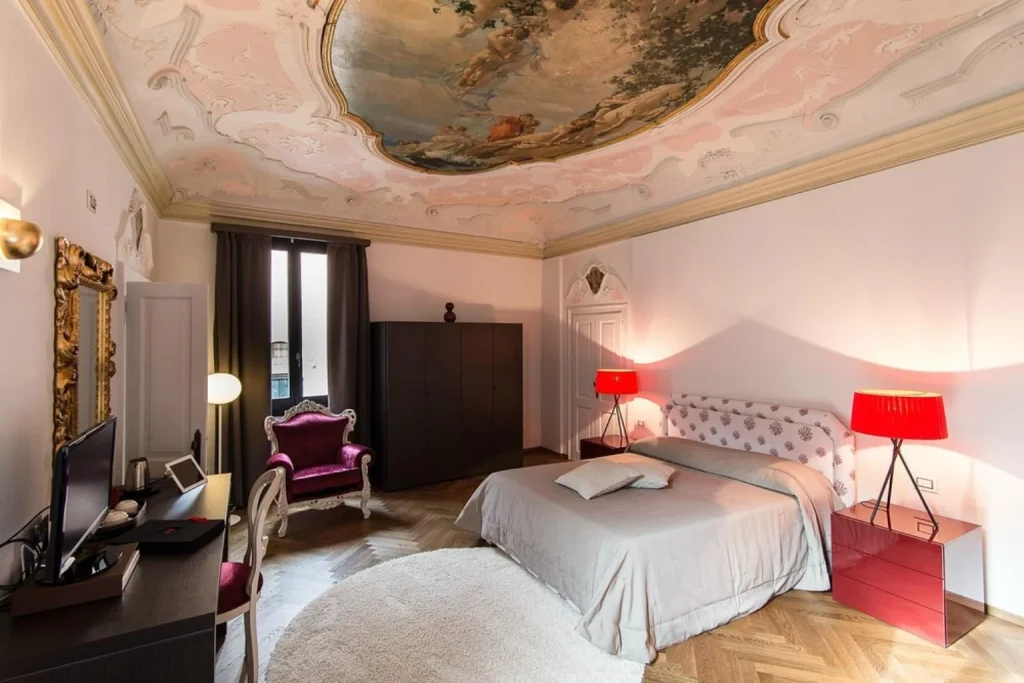Elegant bedroom with frescoed ceiling at Hotel Corte di Gabriela in Venice
