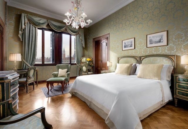 Elegant bedroom with classic Venetian decor and city views at Hotel Danieli, a Four Seasons Hotel in Venice
