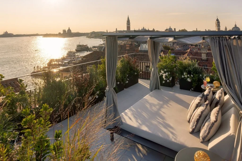 Rooftop terrace with lounge seating and sunset views over the Venetian Lagoon at Hotel Gabrielli Venezia in Venice