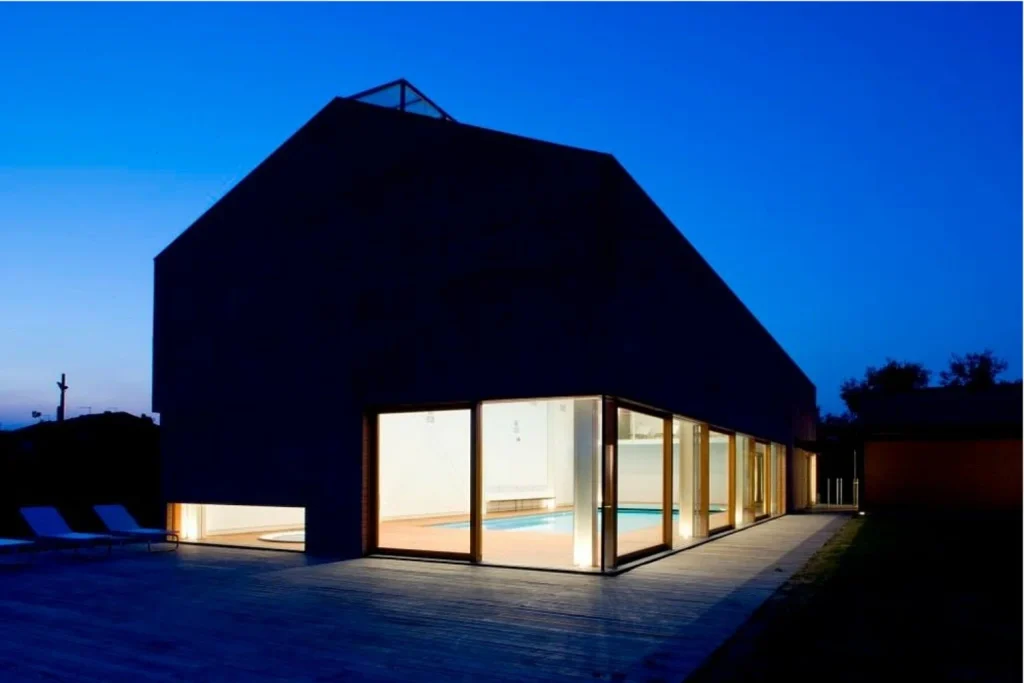Modern indoor swimming pool with wooden decking and skylights at Relais Ormesani in Venice