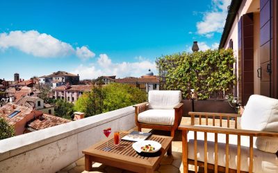 Private rooftop terrace with comfortable outdoor seating and panoramic views over historic Venetian rooftops at Palazzo Venart Luxury Hotel, Venice