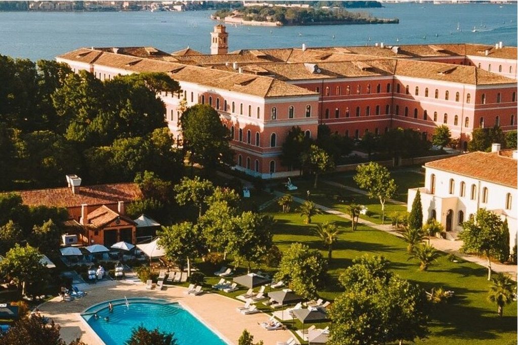 Outdoor swimming pool and landscaped gardens at San Clemente Palace Kempinski Venice, set on a private island in the Venetian Lagoon.