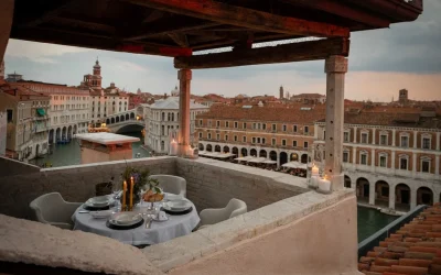 Intimate rooftop terrace with private dining and panoramic views over the Grand Canal and historic rooftops, The Venice Venice Hotel, Venice.